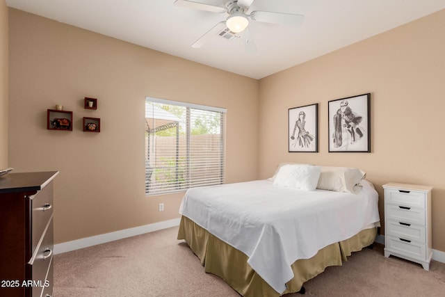 bedroom featuring visible vents, baseboards, light colored carpet, and a ceiling fan