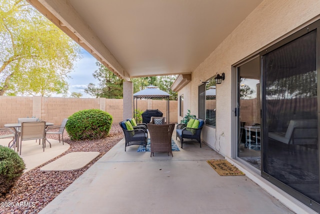 view of patio / terrace with outdoor lounge area, a gazebo, outdoor dining area, and fence