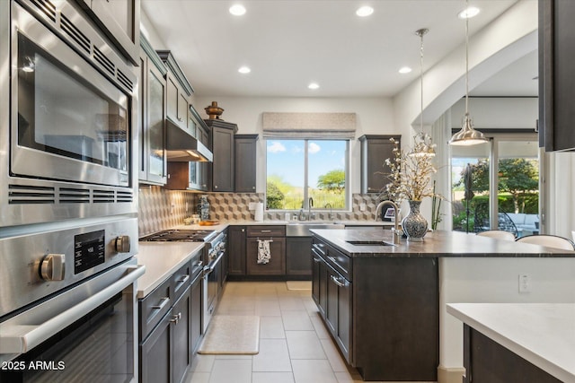 15711 S 11th Ave, Phoenix, AZ 85045 - kitchen with appliances with stainless steel finishes, a sink, backsplash, recessed lighting, and dark brown cabinets