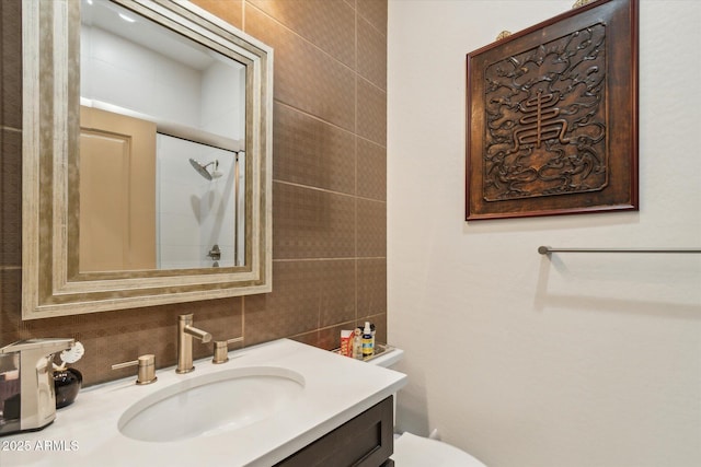 15711 S 11th Ave, Phoenix, AZ 85045 - full bathroom featuring vanity, decorative backsplash, a shower with door, toilet, and tile walls