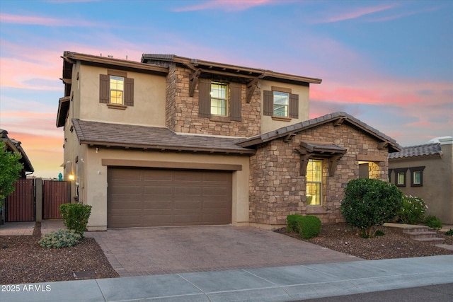 15711 S 11th Ave, Phoenix, AZ 85045 - view of front of home with stucco siding, stone siding, decorative driveway, and a garage