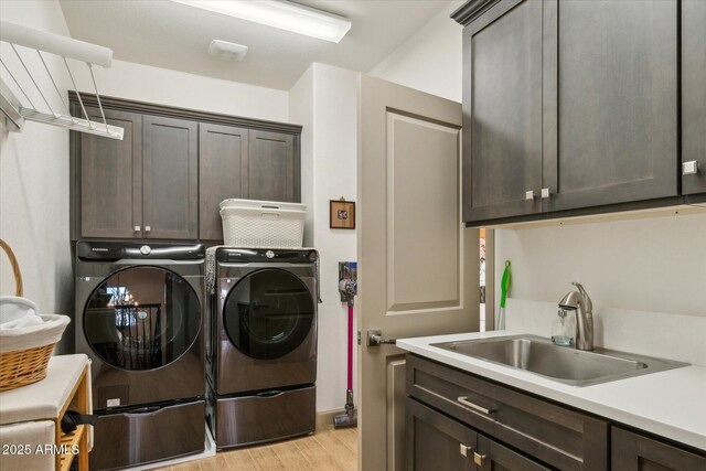 15711 S 11th Ave, Phoenix, AZ 85045 - washroom featuring cabinet space, light wood-style flooring, and washing machine and clothes dryer