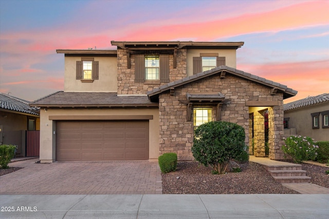 15711 S 11th Ave, Phoenix, AZ 85045 - view of front of home featuring stucco siding, stone siding, decorative driveway, and an attached garage