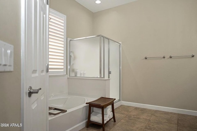 bathroom featuring separate shower and tub