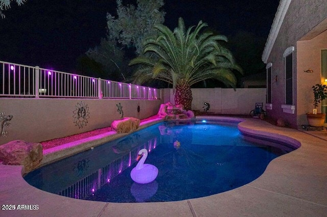 view of pool at twilight