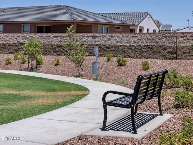 view of home's community featuring a yard and fence