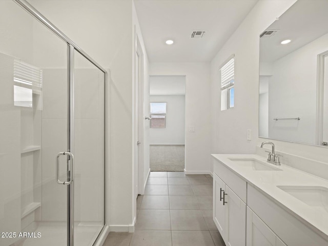 bathroom with visible vents, tile patterned floors, a stall shower, and a sink