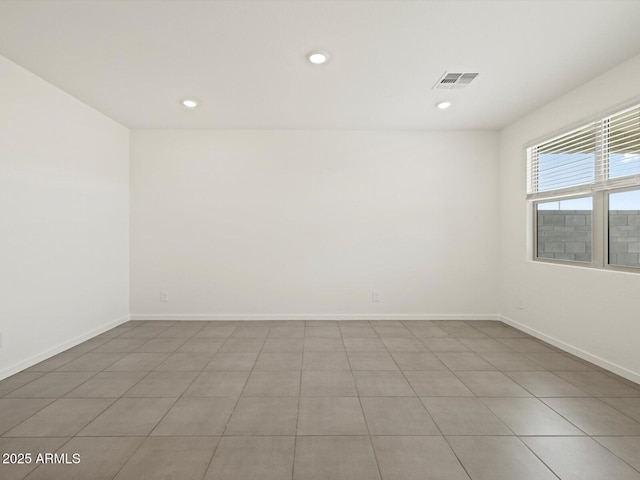unfurnished room featuring recessed lighting, visible vents, and baseboards