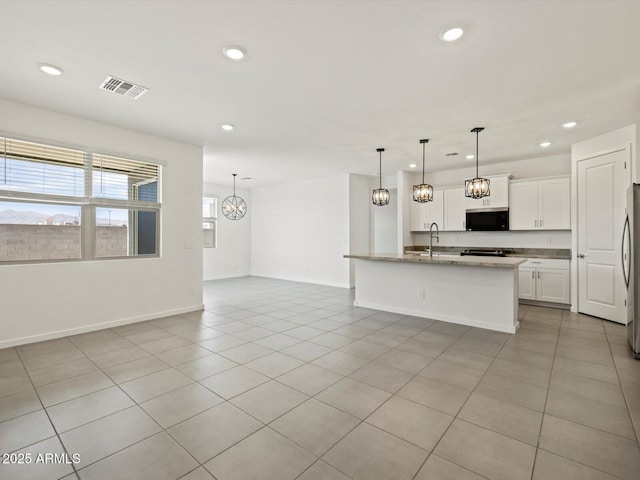 kitchen with recessed lighting, visible vents, and open floor plan