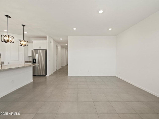 unfurnished living room featuring baseboards and recessed lighting