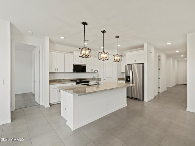 kitchen with white cabinetry, a sink, an island with sink, and appliances with stainless steel finishes
