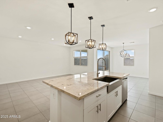 kitchen with recessed lighting, stainless steel dishwasher, light tile patterned floors, a sink, and a notable chandelier