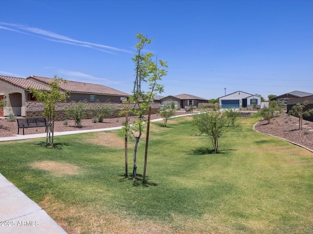view of yard featuring a residential view and a garage