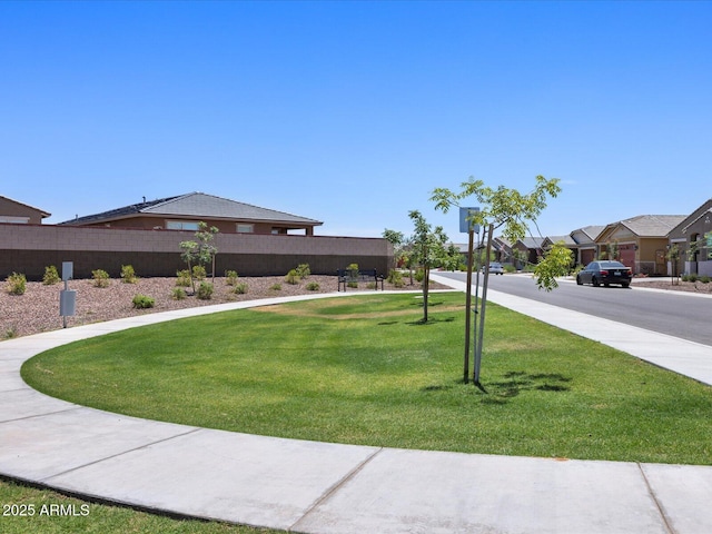 view of yard featuring fence and a residential view
