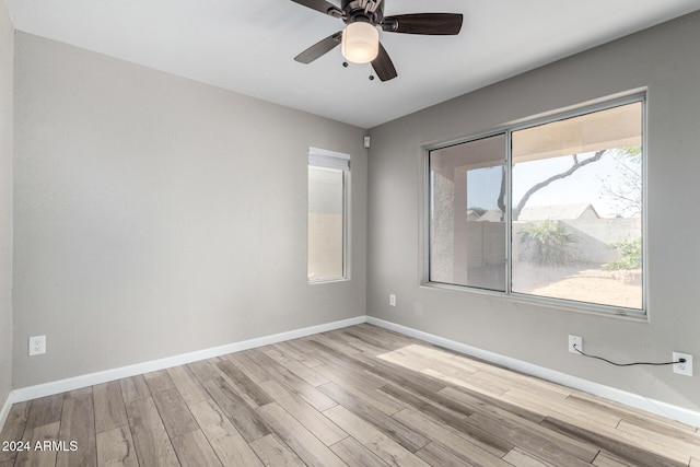 spare room featuring light hardwood / wood-style floors and ceiling fan