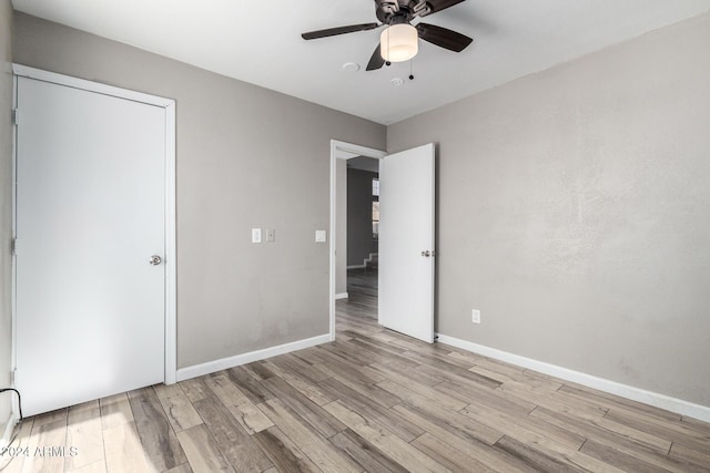 unfurnished bedroom featuring ceiling fan and light wood-type flooring