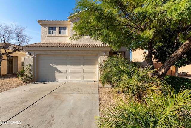 mediterranean / spanish home with a garage