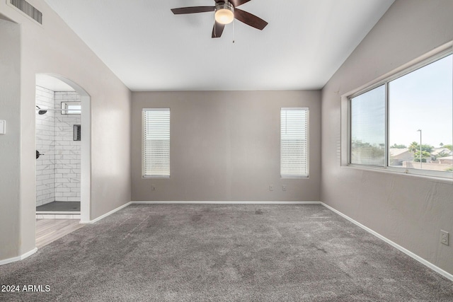 unfurnished room with ceiling fan, carpet, and vaulted ceiling