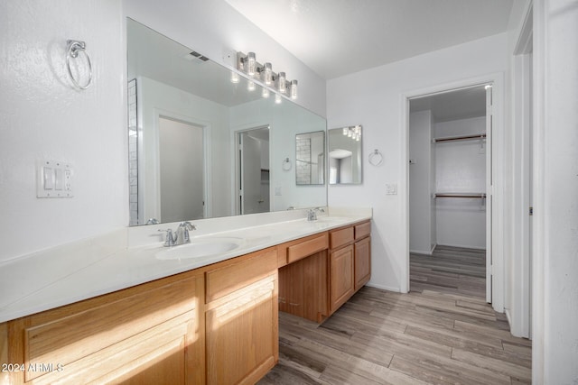 bathroom featuring hardwood / wood-style flooring and vanity