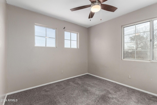 unfurnished room with ceiling fan and carpet