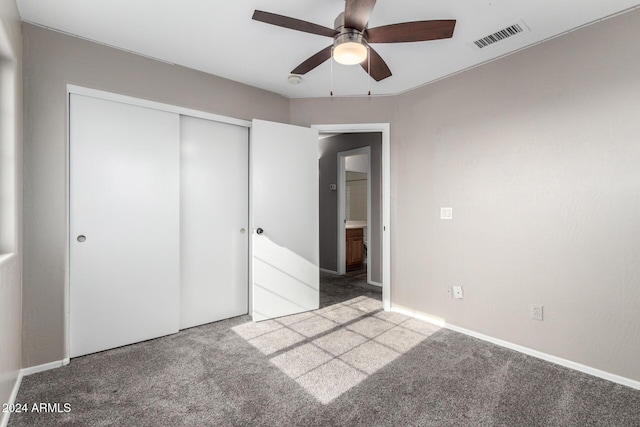 unfurnished bedroom with ceiling fan, light colored carpet, and a closet