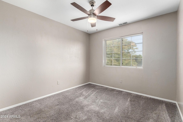 empty room featuring ceiling fan and carpet floors