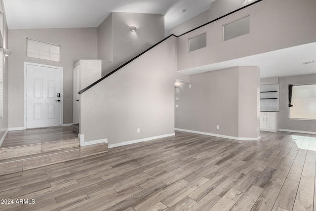 unfurnished living room with a towering ceiling