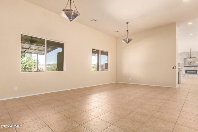 tiled spare room featuring a healthy amount of sunlight