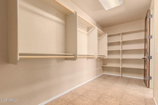 spacious closet with tile patterned flooring