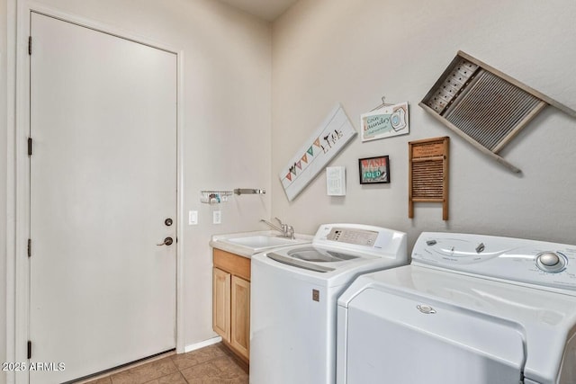 laundry room with sink, light tile patterned floors, cabinets, and washer and dryer