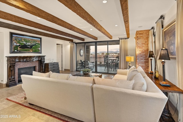 living room featuring beam ceiling and a fireplace