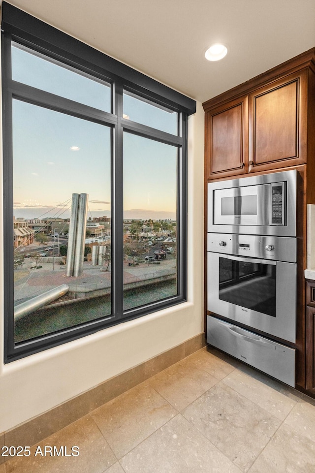 kitchen with light tile patterned floors and stainless steel appliances