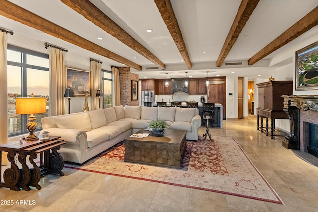 living room featuring beam ceiling and a fireplace