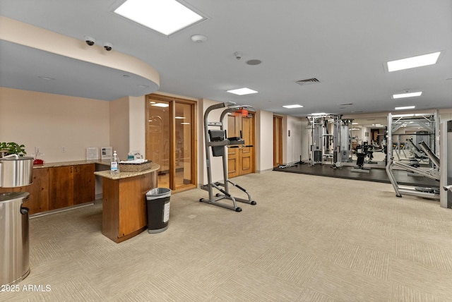 workout area featuring light carpet and wood walls