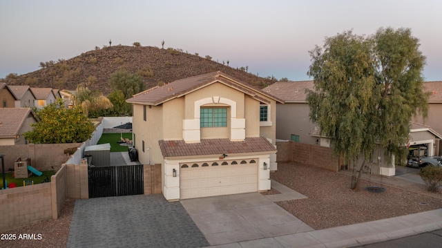 view of front facade with a garage and a mountain view