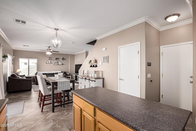 kitchen featuring ceiling fan, ornamental molding, and light tile patterned floors