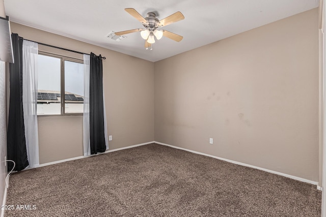 carpeted spare room with ceiling fan