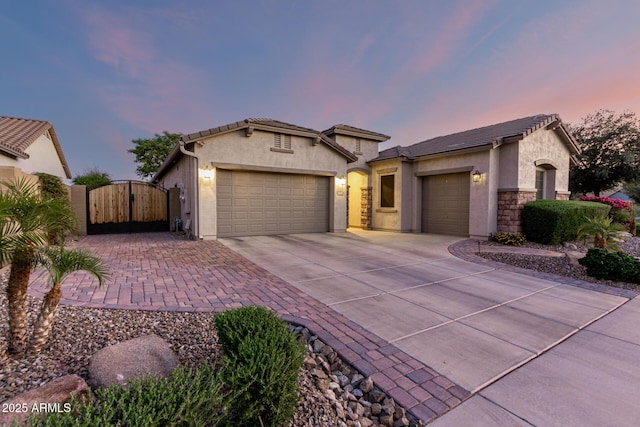 5607 W Alyssa Ln, Phoenix, AZ 85083 - view of front of house with a gate, a garage, driveway, stucco siding, and a tile roof