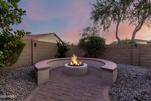 5607 W Alyssa Ln, Phoenix, AZ 85083 - patio terrace at dusk featuring an outdoor fire pit, a patio area, and a fenced backyard