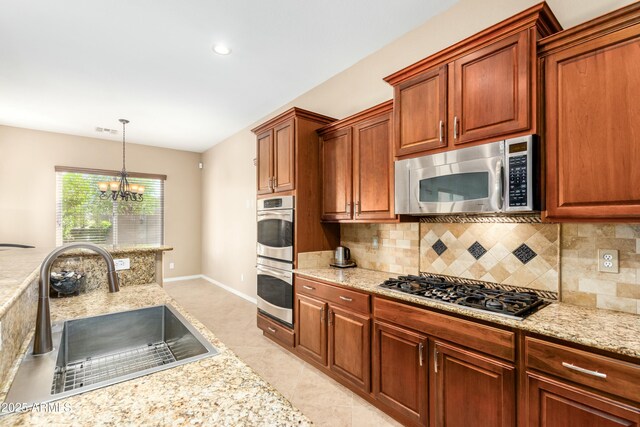 5607 W Alyssa Ln, Phoenix, AZ 85083 - kitchen featuring appliances with stainless steel finishes, tasteful backsplash, a chandelier, decorative light fixtures, and light stone counters