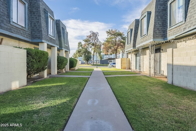 surrounding community featuring fence, a yard, and a residential view
