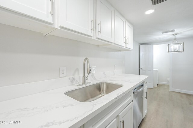 kitchen with a sink, visible vents, light wood-style floors, white cabinetry, and dishwasher