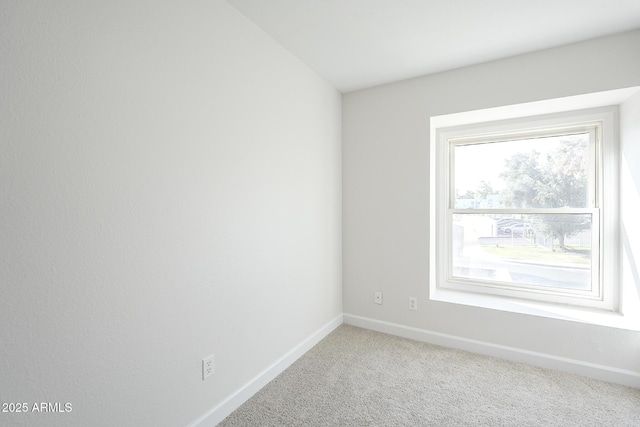 carpeted spare room with baseboards
