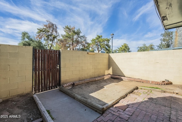 view of patio with fence private yard and a gate