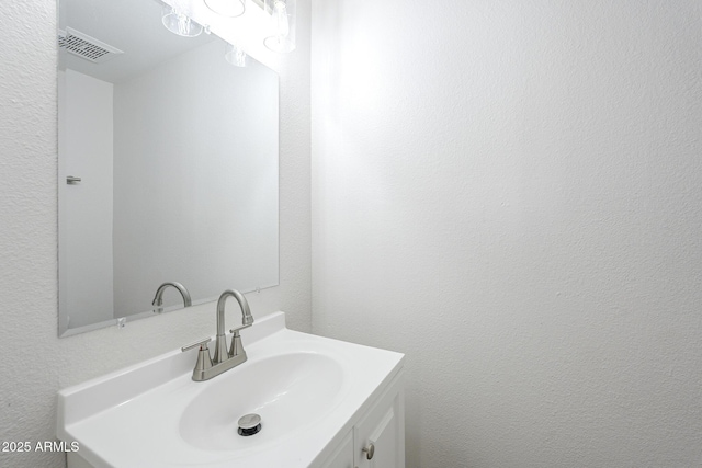 bathroom with visible vents and vanity