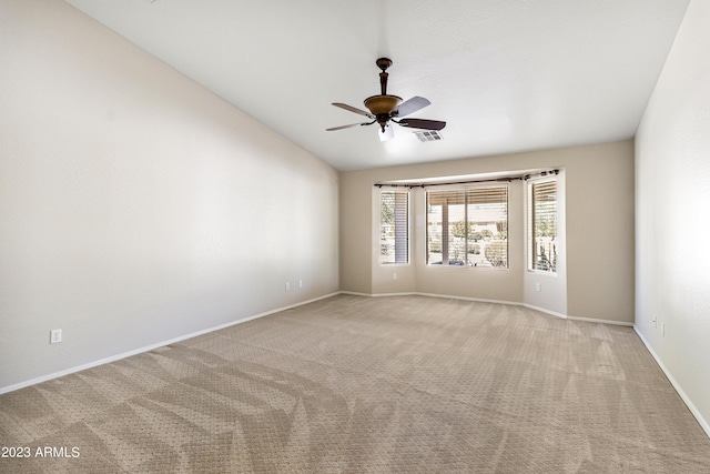 unfurnished room featuring ceiling fan, vaulted ceiling, and light carpet