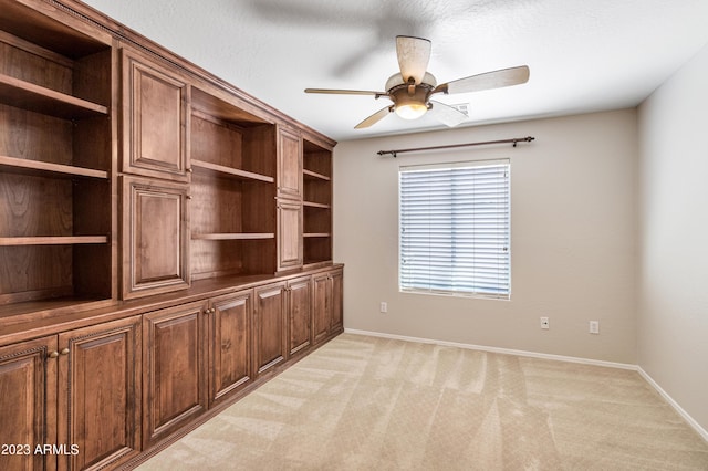 empty room featuring light carpet and ceiling fan