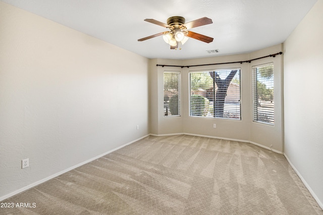 carpeted empty room featuring ceiling fan