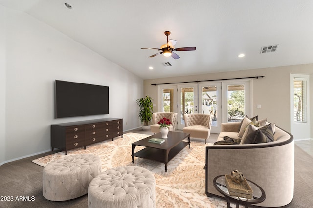 living room featuring ceiling fan, light colored carpet, and lofted ceiling