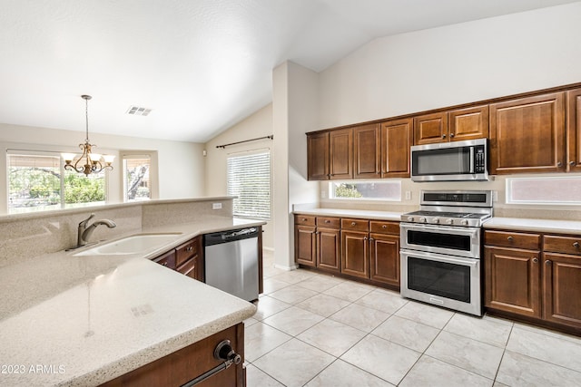 kitchen with sink, vaulted ceiling, appliances with stainless steel finishes, and plenty of natural light